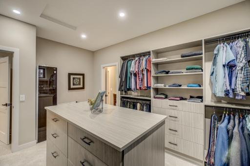 Enjoy your own private dressing room with a built in island dresser and adjustable custom shelving