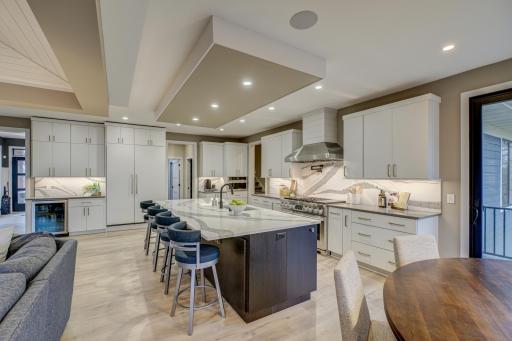 Enjoy cooking your favorite meals in your gourmet kitchen with a stately center island and custom Cambria counters and backsplash