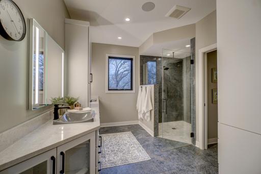 Indulge in your walk-in stone shower with spa jets and rain shower head