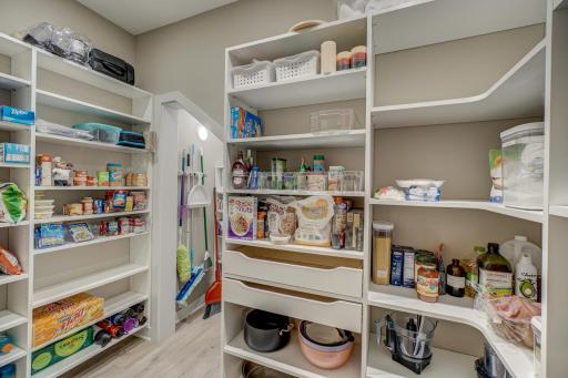 Huge walk-in pantry with custom adjustable shelving and sensor lights
