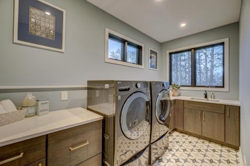 Convenient laundry room located in the primary suite, complete with steam options for your clothes and a separate small load washer