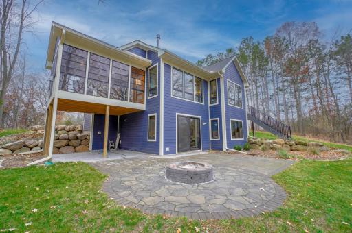 Enjoy the peace and tranquility of nearly 3 acres from this paver patio with a bonfire pit surrounded by majestic oak trees