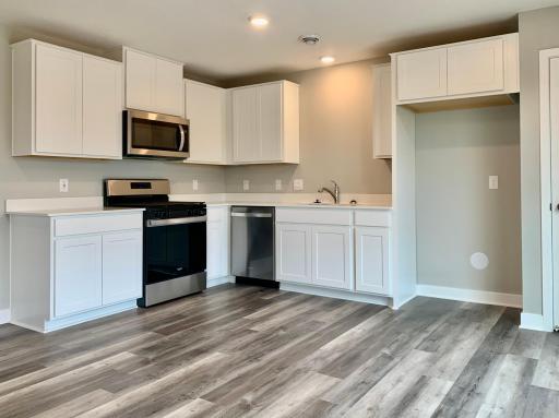 Photo for 19338 136th Avenue N, Rogers, MN 55374 - Listing #6463658 The kitchen in this home features Arctic White cabinets with stainless steel appliances. Photo of actual home.