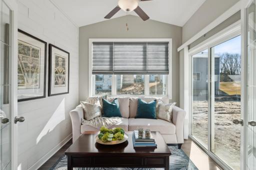 This amazing four season porch is the perfect spot to enjoy your morning coffee! Photo is of a previously built home, colors and finished may vary.