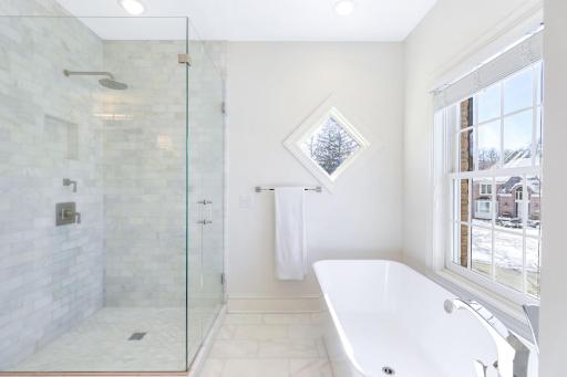 The primary bathroom features a private commode room, walk-in shower, soaking tub, double vanities and a laundry closet that fits full size stack-able units.
