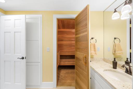 The lower level 3/4 bathroom features a tile shower and separate sauna space.