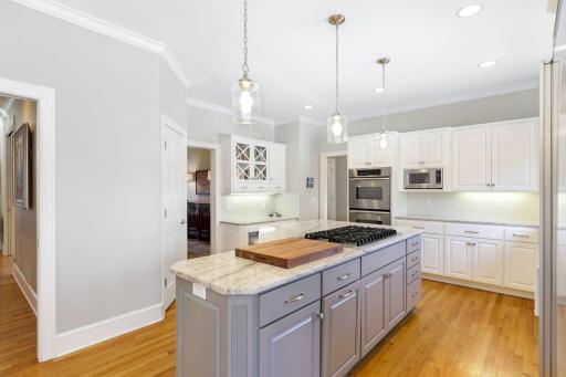 The kitchen has been beautifully remodeled featuring granite countertops, a tile backsplash, Viking gas cooktop, double oven, all stainless steel appliances, a toe-kick central vac feature and more.