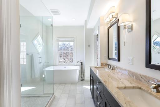The primary bathroom features a private commode room, walk-in shower, soaking tub, double vanities and a laundry closet that fits full size stack-able units.