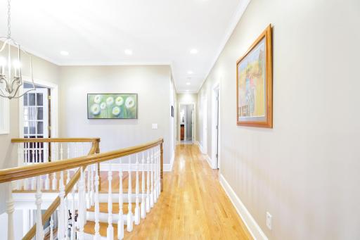 Natural light flows into the upper level hallway through the office windows.