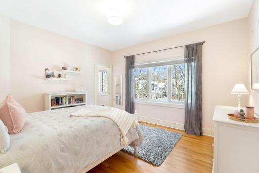 The second of four upper level bedrooms is serviced by a private, full bathroom.