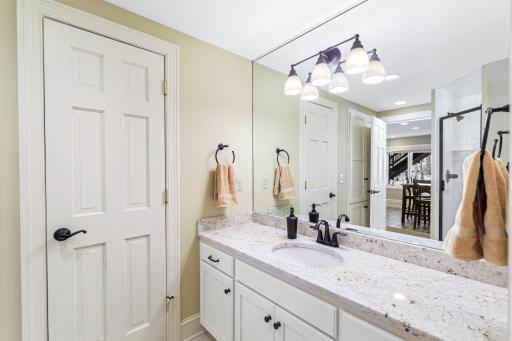 The lower level 3/4 bathroom features a tile shower and separate sauna space.