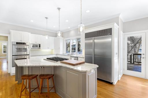 The kitchen has been beautifully remodeled featuring granite countertops, a tile backsplash, Viking gas cooktop, double oven, all stainless steel appliances, a toe-kick central vac feature and more.