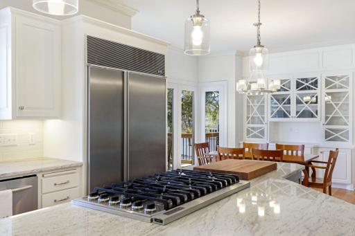 The kitchen has been beautifully remodeled featuring granite countertops, a tile backsplash, Viking gas cooktop, double oven, all stainless steel appliances, a toe-kick central vac feature and more.