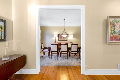 The spacious formal dining room located off the kitchen and foyer and has pocket doors with glass panes that can be closed for more privacy.