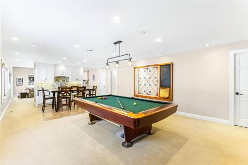 The spacious amusement room is great for entertaining and features a wet bar with a beverage fridge.