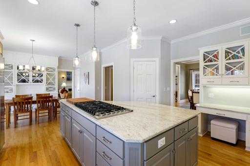 The kitchen has been beautifully remodeled featuring granite countertops, a tile backsplash, Viking gas cooktop, double oven, all stainless steel appliances, a toe-kick central vac feature and more.