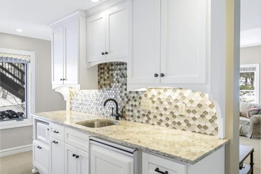 The spacious amusement room is great for entertaining and features a wet bar with a beverage fridge.