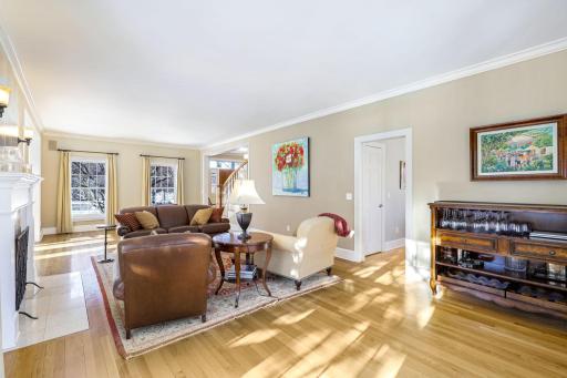 The living room is open to the foyer, sunroom and walks into the kitchen/dining space.