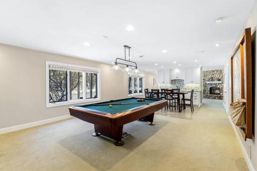The spacious amusement room is great for entertaining and features a wet bar with a beverage fridge.