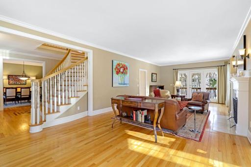 The main level living room is bright and open with natural light coming in through 3 sides of the home including the adjoining 5-sided sunroom.