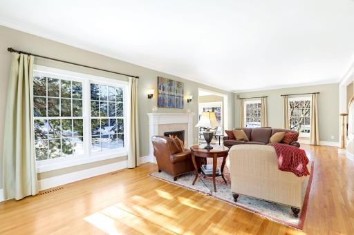 The living room is open to the foyer, sunroom and walks into the kitchen/dining space.
