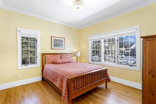 The main floor offers a guest wing where a doorway buffers the mudroom, a bedroom, a 3/4 bath and laundry.