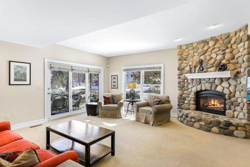 The cozy lower level family room walks out to the backyard paver patio overlooking the pond.