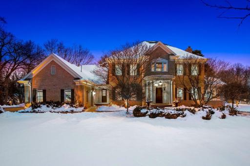 The exterior features luxurious detail including an all brick exterior, a paver driveway and paver/stone paths.