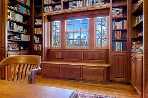 The upper level office has luxurious custom finishings and a window looking out over the stairway.
