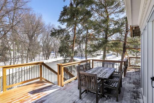 The deck was replaced in 2023 and looks out to the private backyard, pond and abundant wildlife.