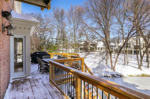 The deck was replaced in 2023 and looks out to the private backyard, pond and abundant wildlife.