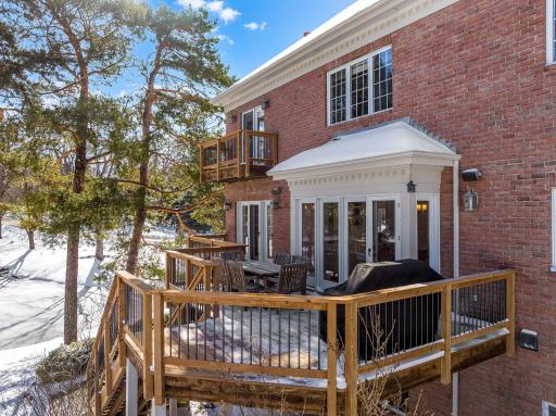 The deck was replaced in 2023 and looks out to the private backyard, pond and abundant wildlife.