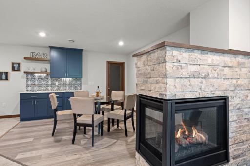 Three sided fireplace adds warmth and ambience throughout
