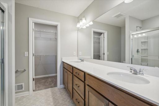 Dual sinks, quarts counters, large shower with semi-frameless door