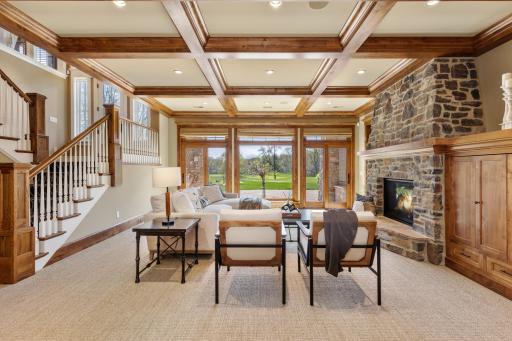Lower Level Family Room with gas fireplace and wall of windows overlooking golf course