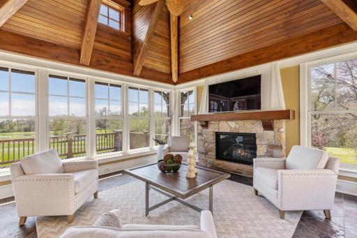 Sunroom with in floor heat and gas fireplace and soaring ceilings