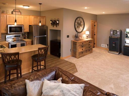 Lower level kitchen/bar area is great for entertaining and open to family room/game table space!