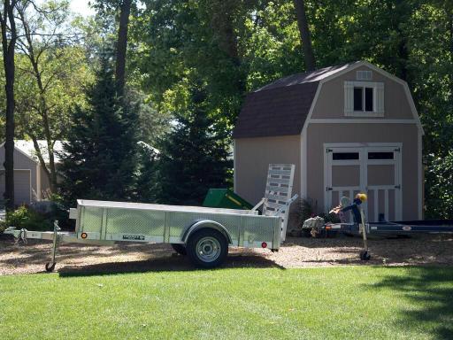 Large storage shed and parking area for guests, toys, and equipment.
