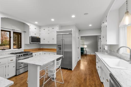 Kitchen with Carrara look countertops, center island, adjacent to Butlers Pantry