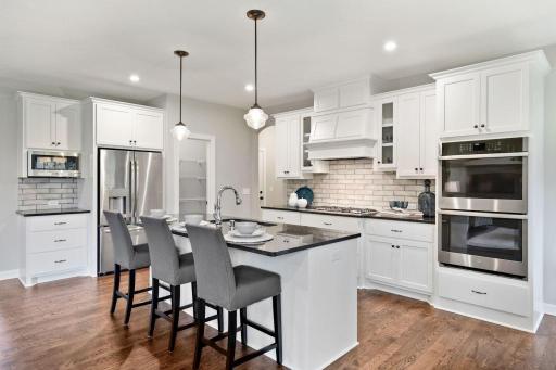 Our gourmet kitchen defines how the WOW comes standard. With a huge center island, granite countertops, gas cook top, and double ovens, plus so much more! (pic from a previous model).jpg