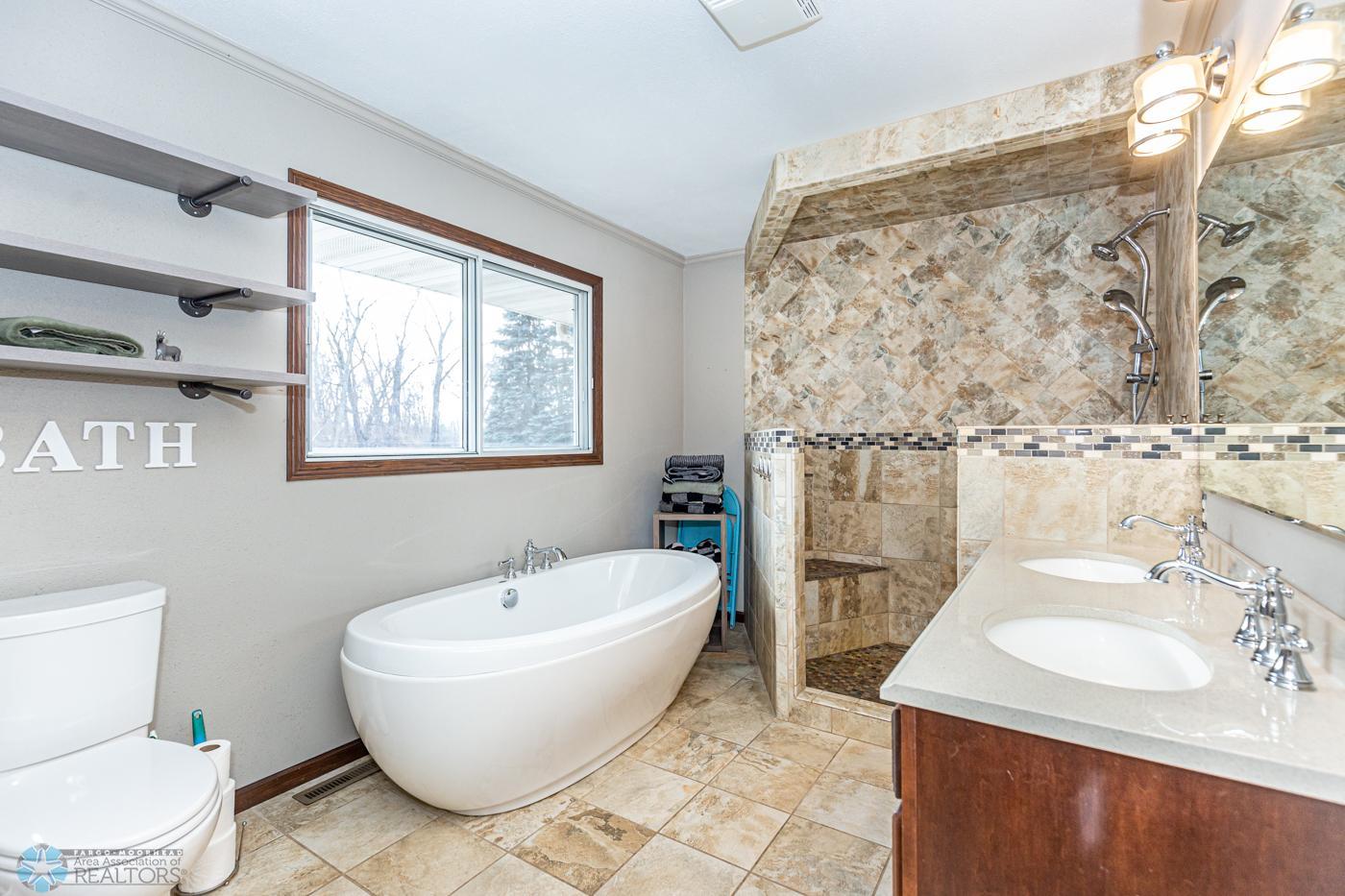 Primary Bathroom 5 piece custom tile bathroom located adjacent to the primary bathroom