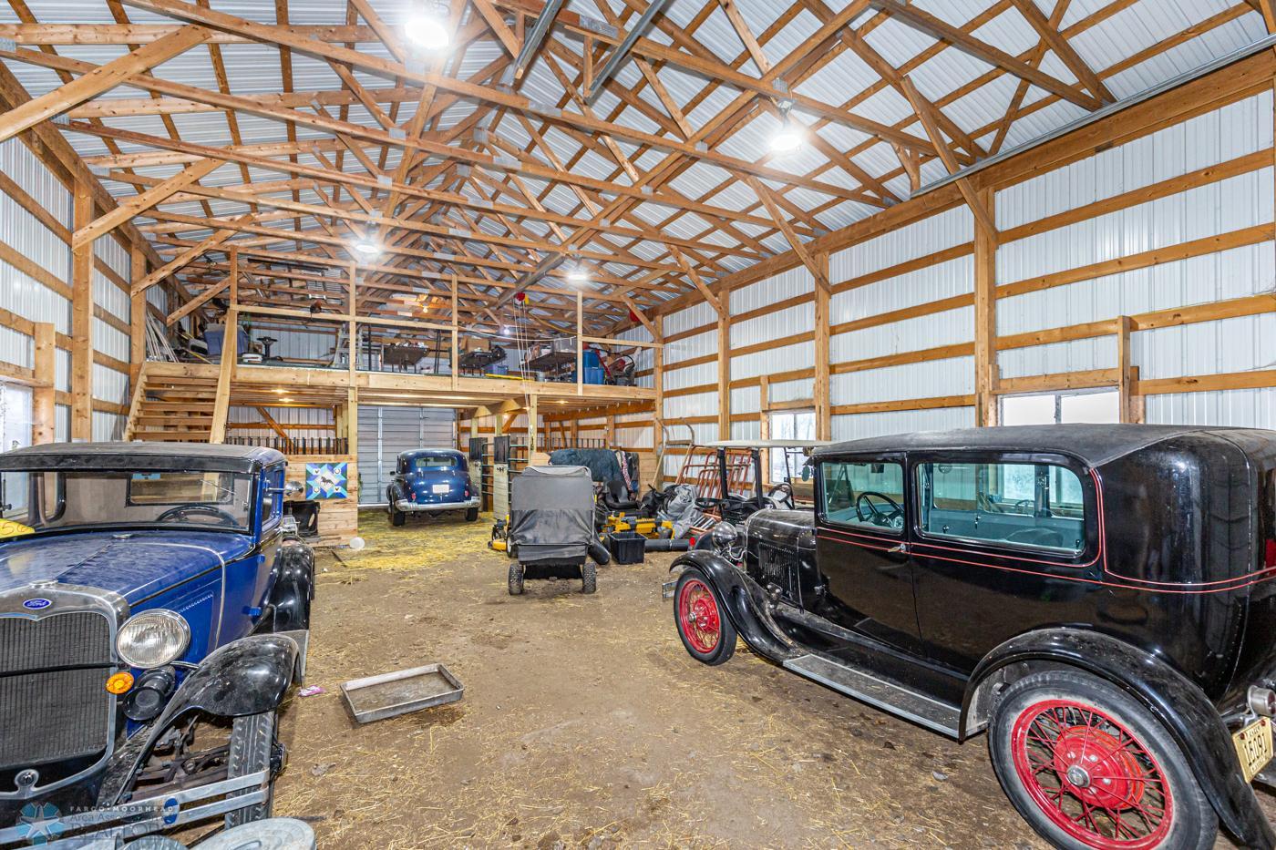 62 x 32 (approx.) Barn with 3 14 foot doors, 5 stalls, tack area, and loft.