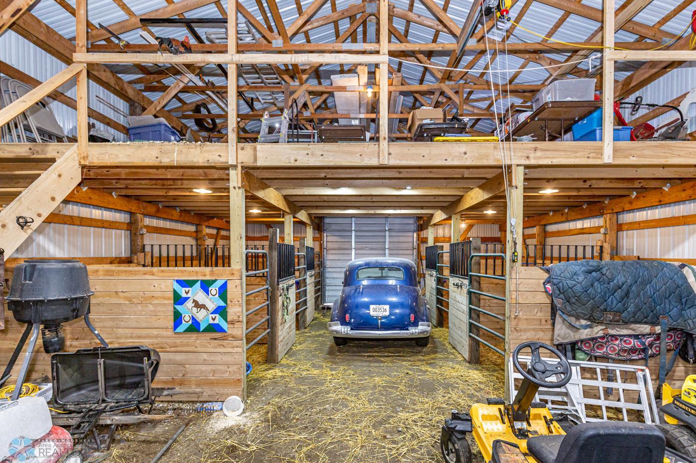 Barn 62 x 32 (approx.) Barn with 3 14 foot doors, 5 stalls, tack area, and loft.