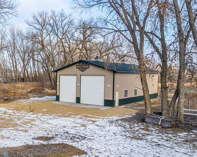 62 x 32 (approx.) Barn with 3 14 foot doors, 5 stalls, tack area, and loft.