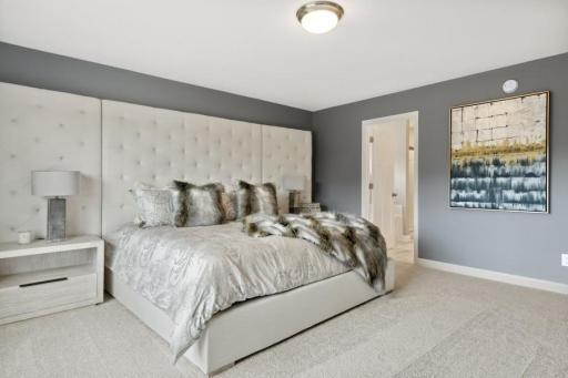 Spacious, stunning primary suite. (Photo is of a decorated model, actual homes features may vary)