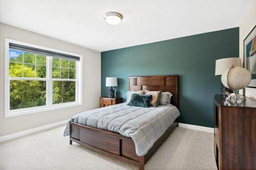 One of three generously sized upper level secondary bedrooms all with walk-in closets. *Please note, photos are of a model, features and colors in actual home will vary. Please contact listing agent for exact specifications.