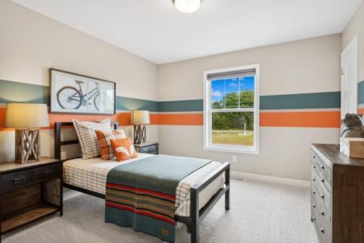 The second generously sized upper level secondary bedroom with a walk-in closet. (Photo is of a decorated model, actual homes features may vary)