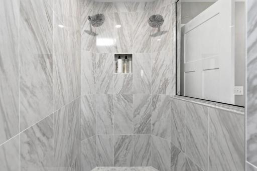 Serenity bathroom walk in shower with 2 shower heads. (Photo is of a decorated model, actual homes features may vary)