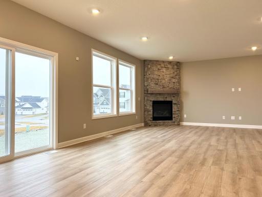 Progress photo great room with stunning ceiling high stone fireplace!
