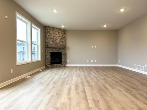 Progress photo great room with stunning ceiling high stone fireplace!